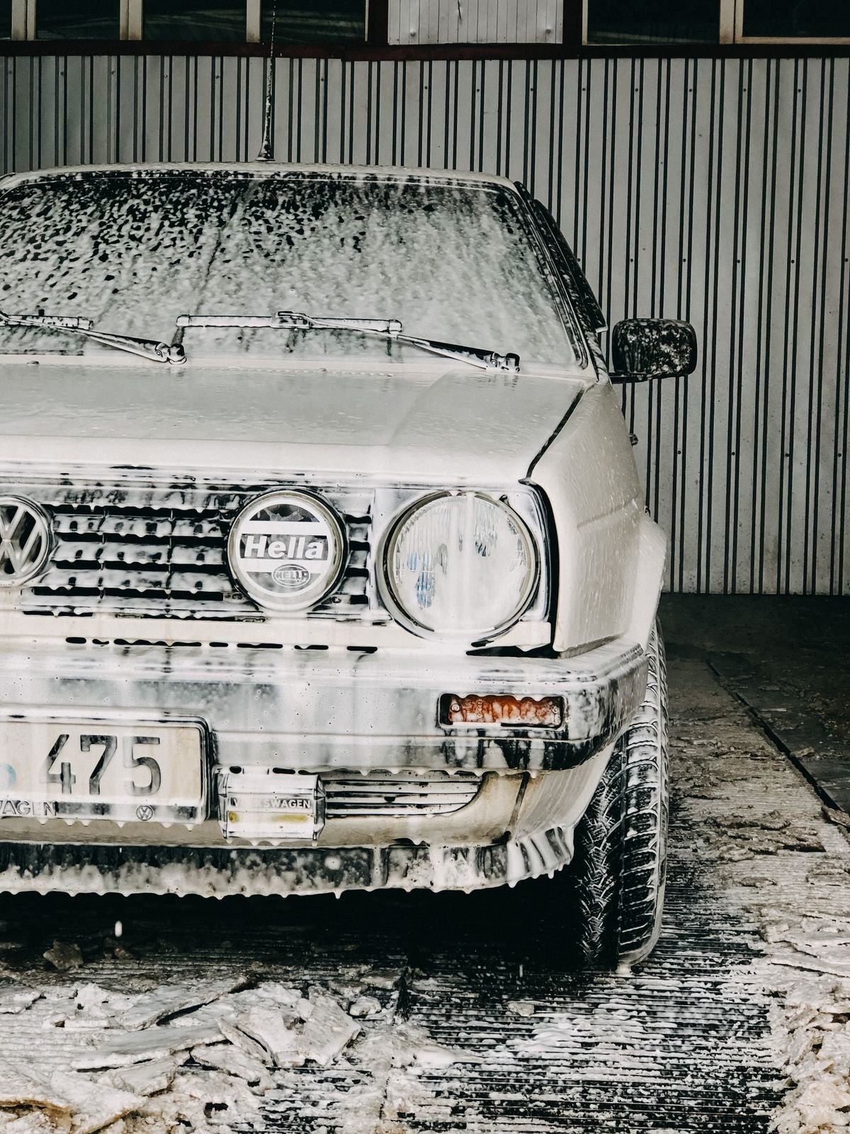 Car exterior covered in wash soap suds